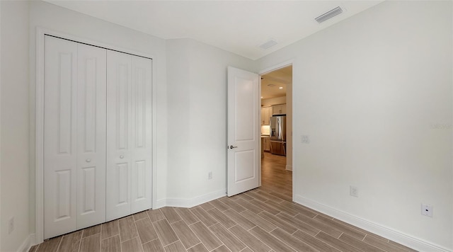 12649 Palatka Dr, Venice, FL 34293 - unfurnished bedroom featuring stainless steel refrigerator with ice dispenser and a closet