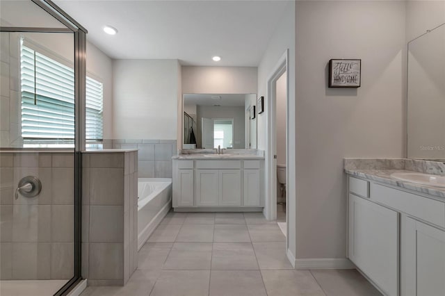 full bathroom featuring tile patterned flooring, vanity, toilet, and plus walk in shower