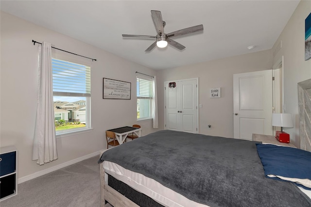 bedroom featuring light carpet, a closet, and ceiling fan