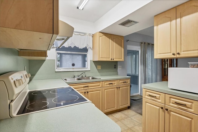 kitchen with white appliances, sink, and light brown cabinets