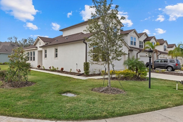 view of side of property featuring a garage and a lawn