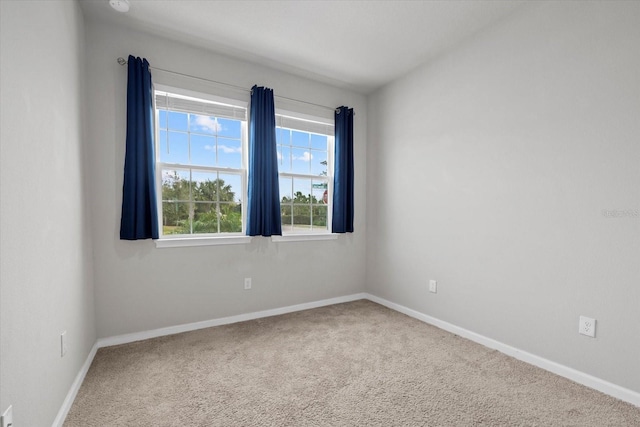 carpeted spare room featuring a healthy amount of sunlight