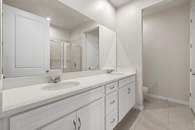 bathroom with toilet, vanity, tile patterned floors, and an enclosed shower