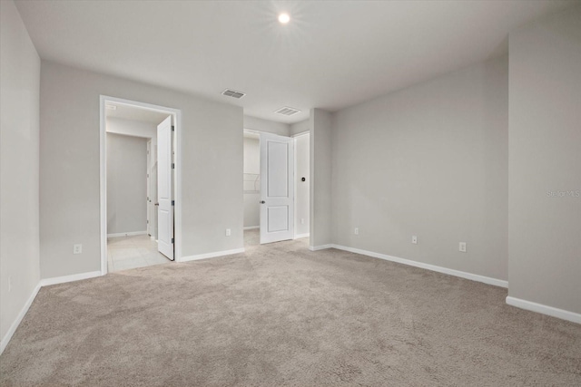 spare room featuring light colored carpet