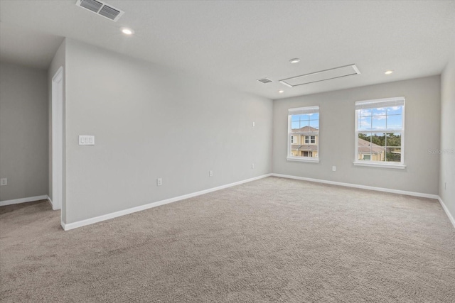 spare room featuring light colored carpet