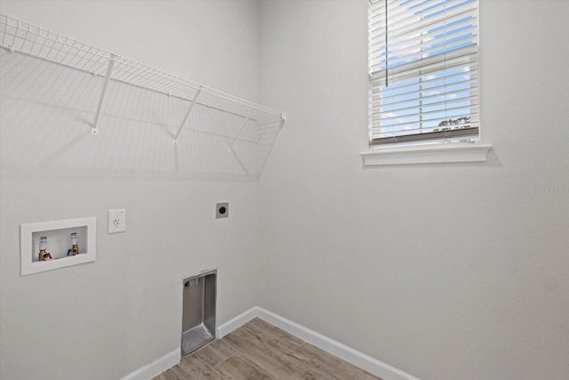 washroom featuring wood-type flooring, washer hookup, and hookup for an electric dryer