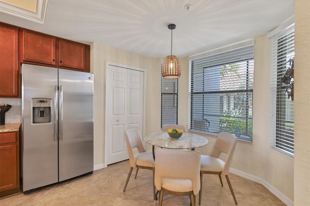 dining space featuring light tile patterned floors