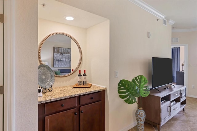 bathroom featuring tile patterned floors, crown molding, and vanity