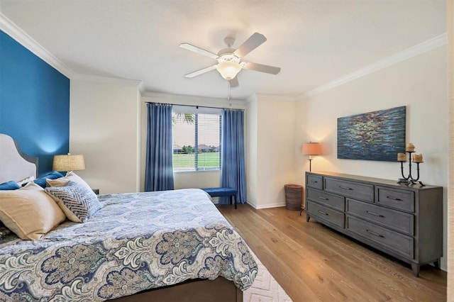 bedroom with ceiling fan, light wood-type flooring, and crown molding