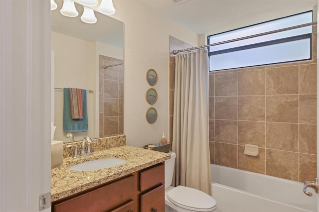 full bathroom with vanity, toilet, and shower / bath combo with shower curtain