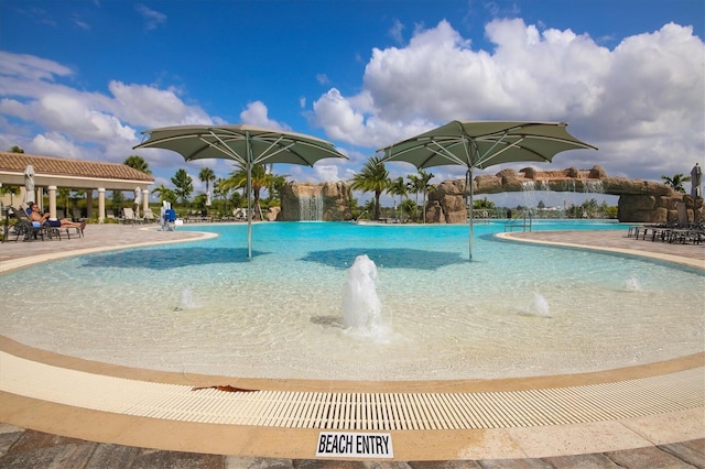 view of swimming pool featuring pool water feature