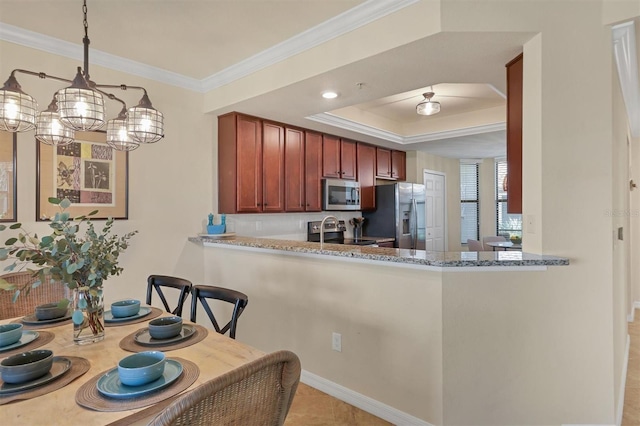 kitchen featuring kitchen peninsula, light stone countertops, hanging light fixtures, and stainless steel appliances