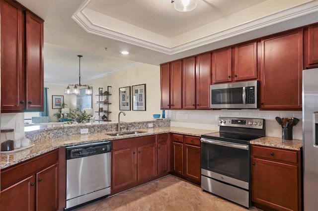 kitchen featuring light stone countertops, sink, stainless steel appliances, pendant lighting, and a tray ceiling