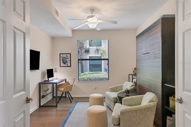 office space featuring light wood-type flooring and ceiling fan