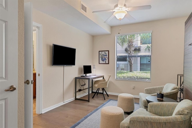 office space with light hardwood / wood-style flooring and ceiling fan