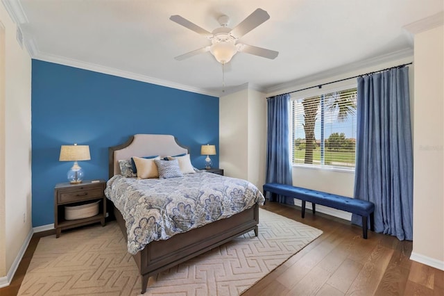 bedroom featuring wood-type flooring, ceiling fan, and ornamental molding