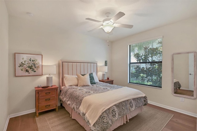 bedroom with hardwood / wood-style floors and ceiling fan