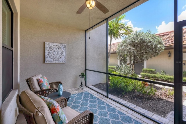 sunroom featuring ceiling fan