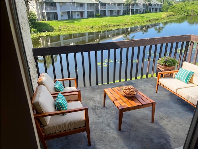 balcony featuring outdoor lounge area and a water view