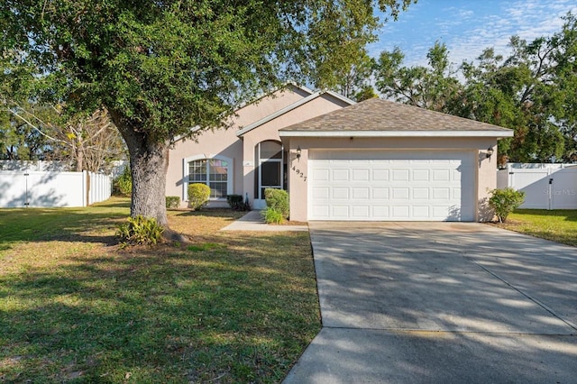 single story home with a front lawn and a garage