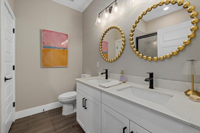 bathroom featuring an enclosed shower, vanity, and toilet