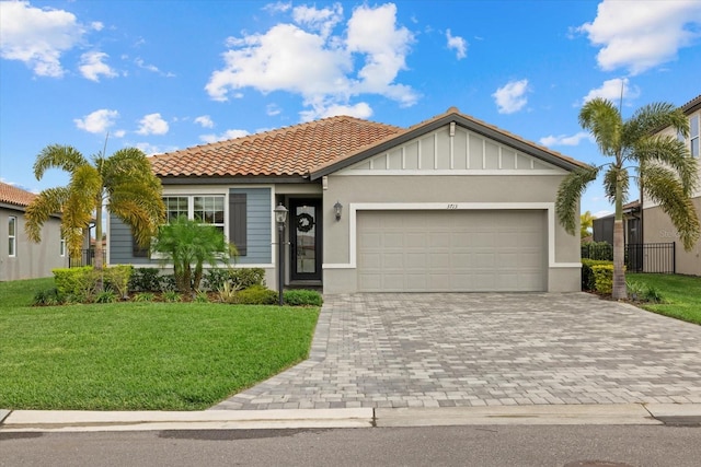 view of front of home with a garage and a front lawn