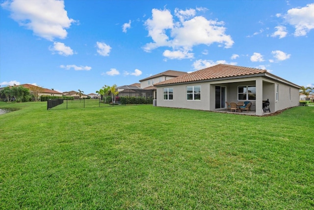 rear view of property with a patio area and a yard