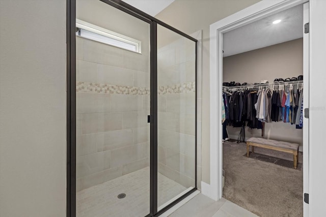 bathroom with a shower with door