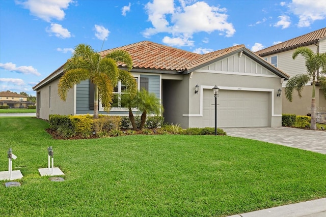 view of front of home featuring a garage and a front lawn