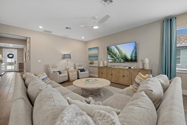 living room with ceiling fan and light hardwood / wood-style floors