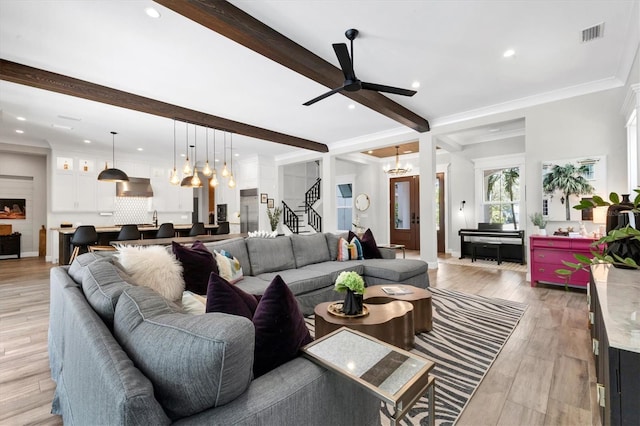 living room with ceiling fan, light hardwood / wood-style flooring, beamed ceiling, and ornamental molding