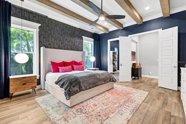 bedroom featuring beamed ceiling, ceiling fan, and light hardwood / wood-style floors