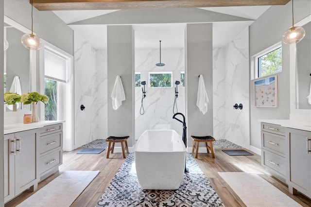 bathroom featuring plus walk in shower, vanity, lofted ceiling with beams, and tile walls