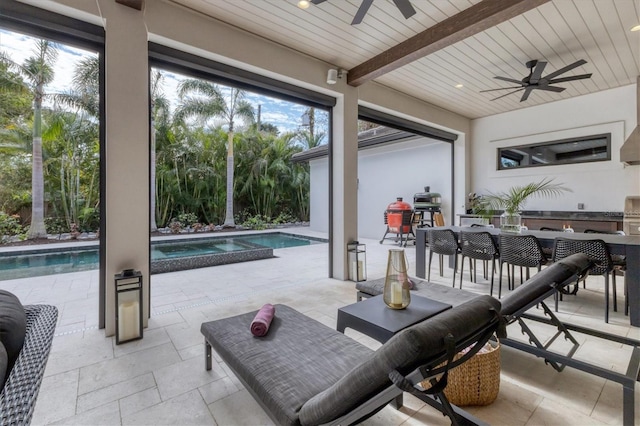 view of patio / terrace featuring ceiling fan and exterior bar