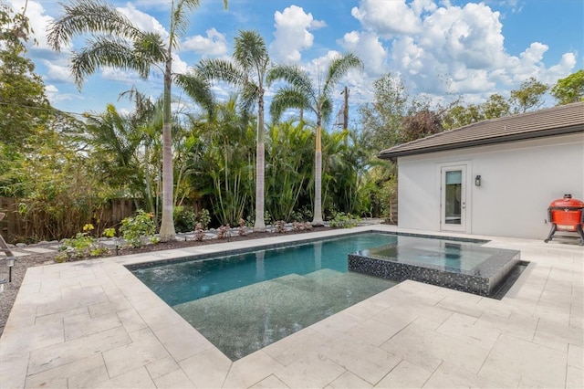 view of pool featuring an in ground hot tub and a patio