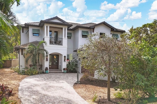 view of front of house featuring a balcony and a garage