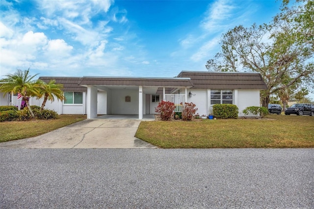 ranch-style home featuring a carport and a front yard