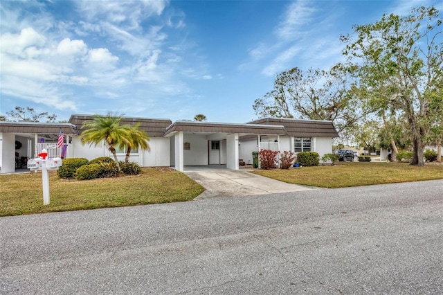 single story home with a front yard and a carport