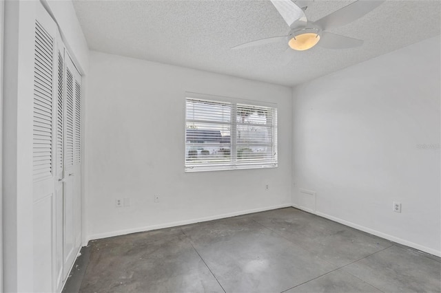 unfurnished bedroom with a textured ceiling, ceiling fan, and a closet