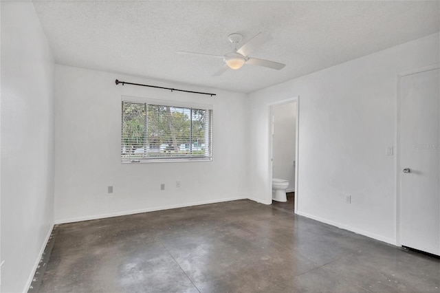 empty room with a textured ceiling and ceiling fan