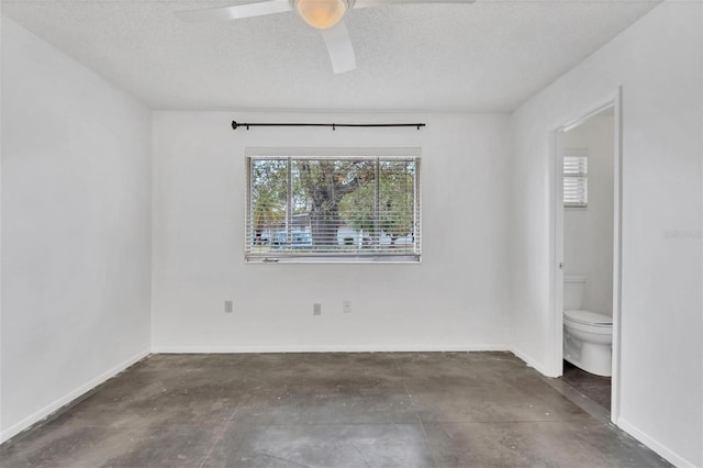 spare room featuring a textured ceiling and ceiling fan