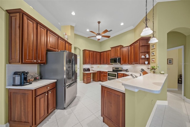 kitchen with sink, stainless steel appliances, kitchen peninsula, decorative light fixtures, and light tile patterned floors