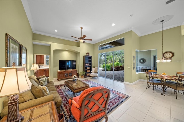 living room featuring light tile patterned floors, ceiling fan with notable chandelier, and ornamental molding