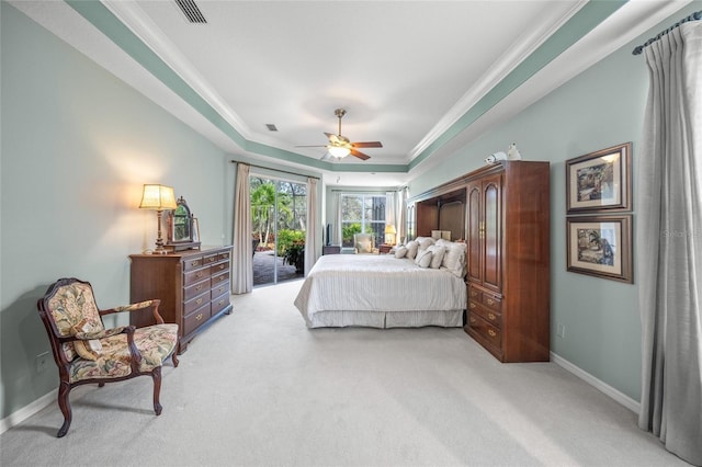 bedroom featuring a tray ceiling, access to exterior, ceiling fan, and light colored carpet