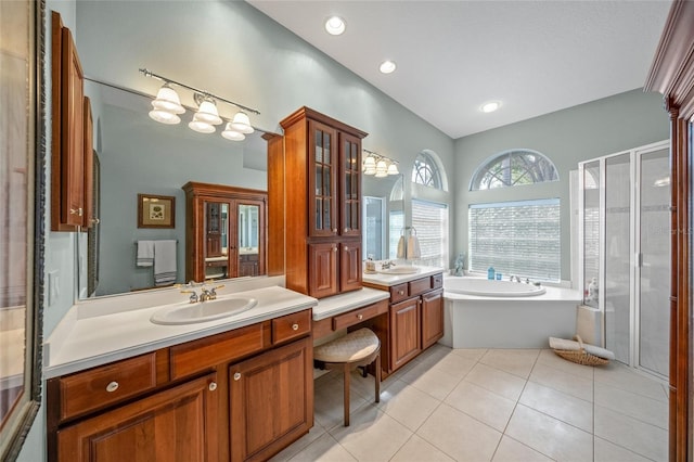 bathroom with tile patterned flooring, vanity, and separate shower and tub