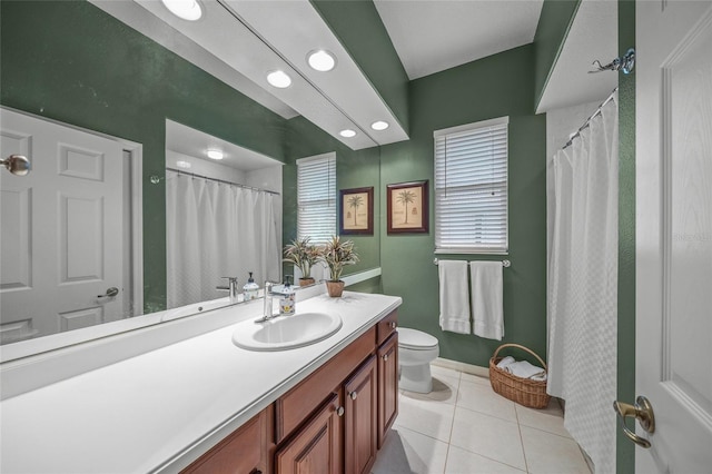 bathroom featuring tile patterned flooring, vanity, and toilet