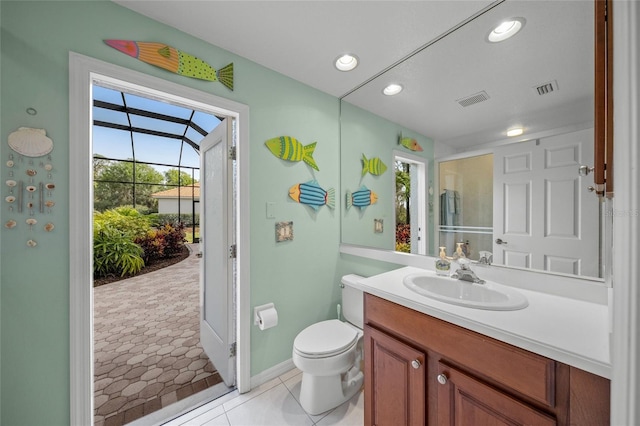 bathroom featuring tile patterned flooring, vanity, and toilet