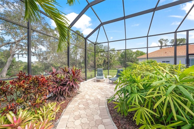 view of patio featuring glass enclosure