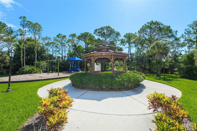 view of community with a gazebo, a playground, and a yard