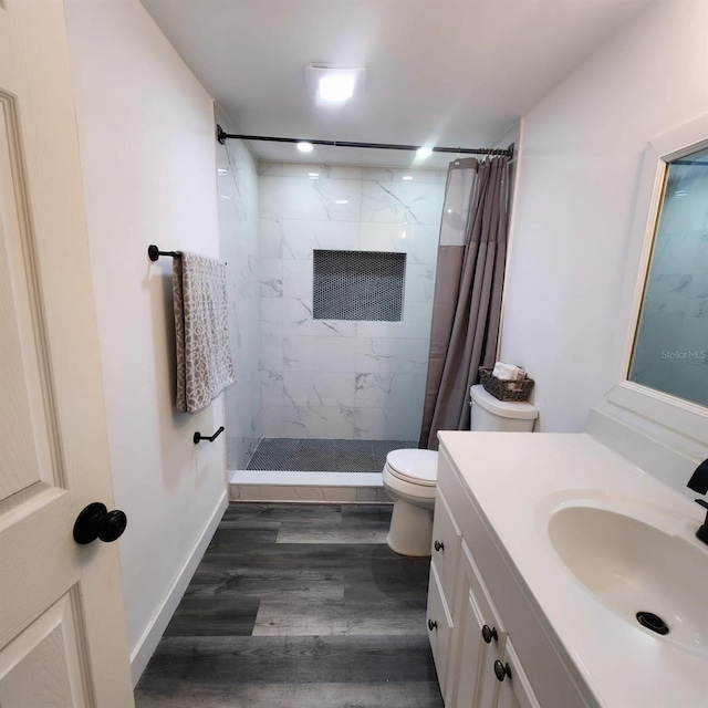 bathroom featuring a shower with curtain, vanity, toilet, and hardwood / wood-style flooring